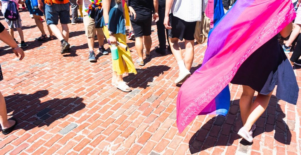 woman-draped-with-bisexual-pride-flag-to-show-representation-for-those-who-identify-as-bisexual_t20_lR9Pgw