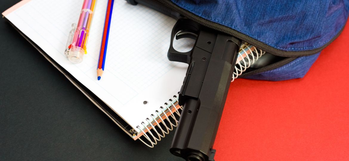 A firearm on the backpack of a young man at school, a loaded gun